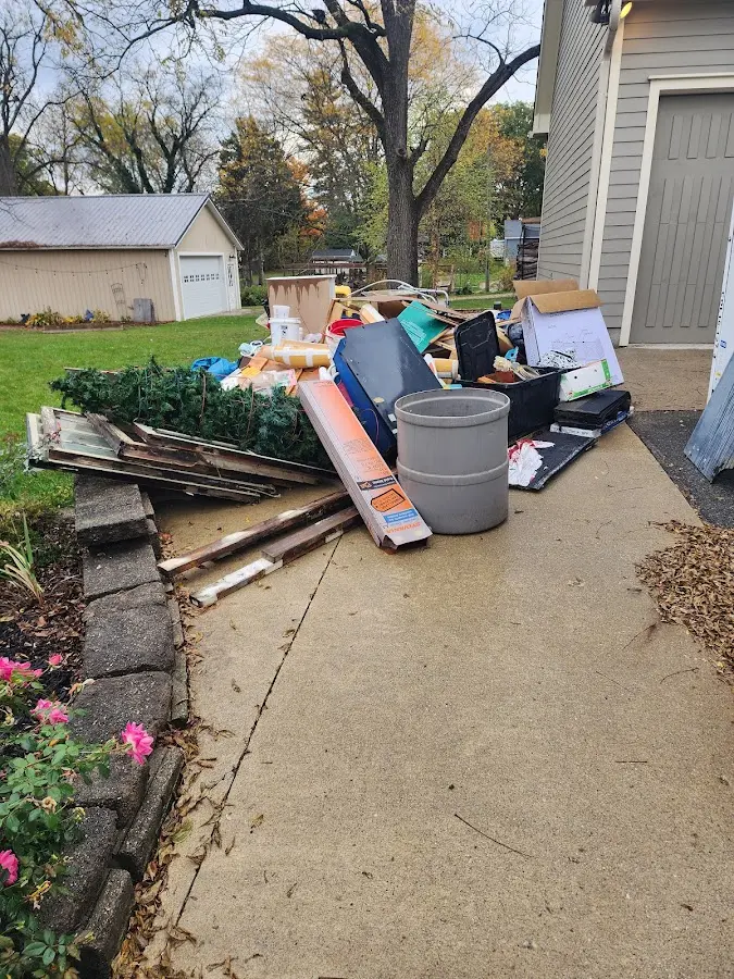Dumpster being loaded with debris for 12 Yard Dumpster Rental in Mitchell